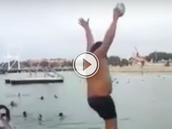 Man jumps into a lake with a ball and ball rockets up (Video)