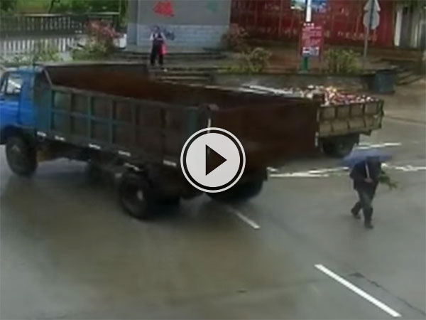 Near miss between truck and man in China (Video)