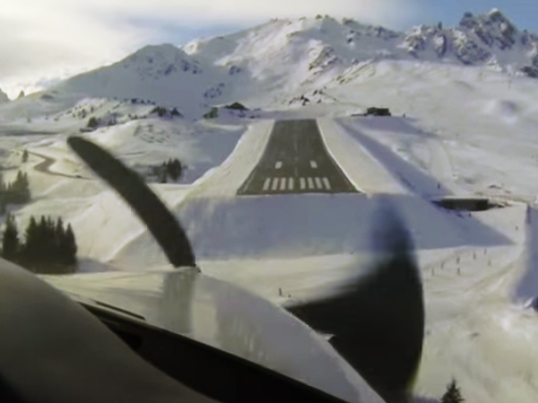 Someone clicks a picture of the snowy runway from the inside because of the wing visible in it.