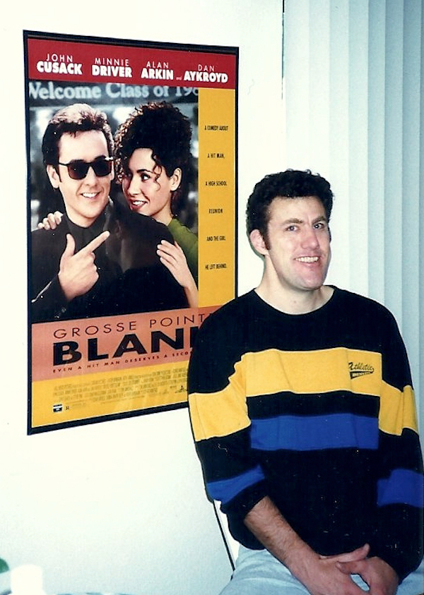 Posing in front of movie poster jubilant.