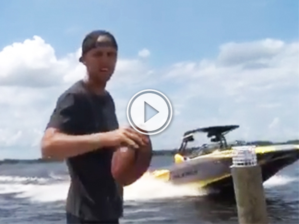 Wakeboarder splendidly catches a football mid backflip (video grab)