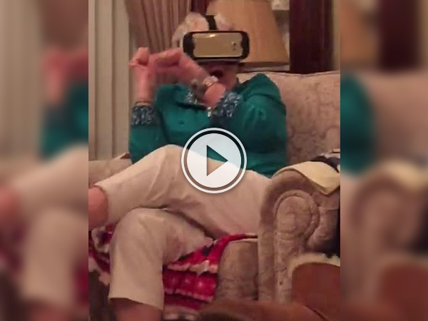 Screenshot of a video with an old woman whose eyes are tied up by a mobile phone