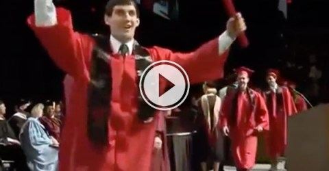 Dude in red graduation gown exults after getting the degree!