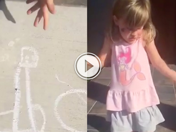 A chalk drawing on concrete and a little girl in grey skirt and pink top!