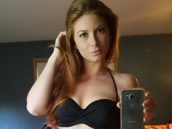 Hot chick taking selfie in a black bikini top