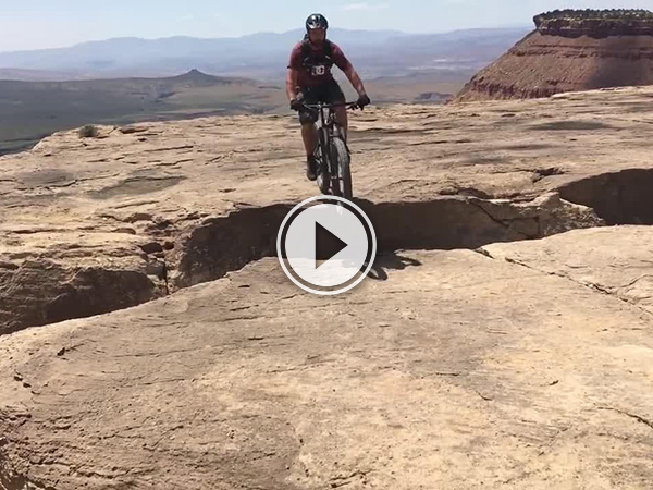 Screenshot of a mountain biker on a cliff