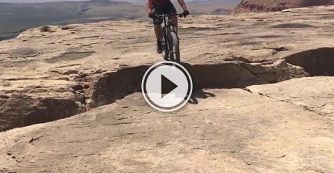 Screenshot of a mountain biker on a cliff
