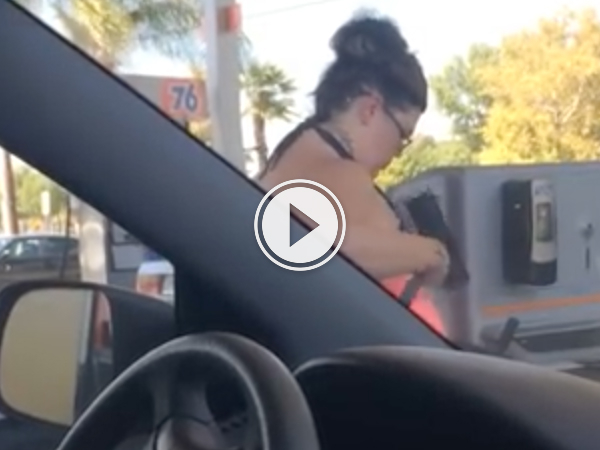 Woman bathes herself with gas station squeegee