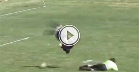 High school soccer player flips over goalie (Video)