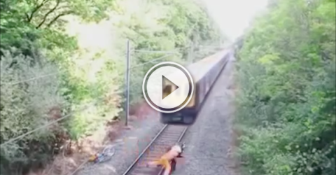 Drunk guy has trouble with tracks and narrowly avoids a train (Video)