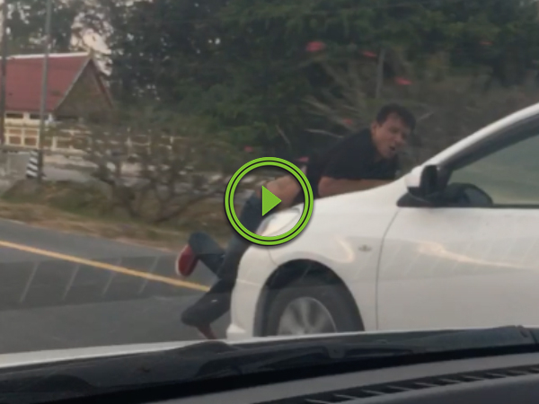 Guy gets stuck on hood of car while driving down road (Video)