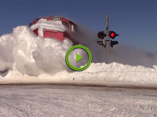 Train obliterates massive snowbank (Video)
