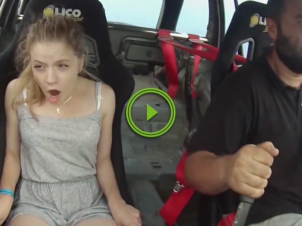 Cute girl goes for a ride in a race car, delightfully overwhelmed (Video)