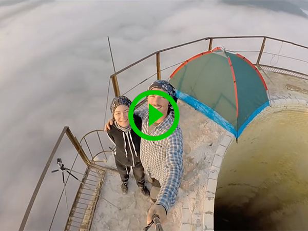 Insane daredevil camps on and climbs around atop chimney