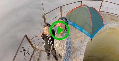 Insane daredevil camps on and climbs around atop chimney