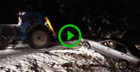 Tractor pulling car out of ditch only makes it worse (Video)