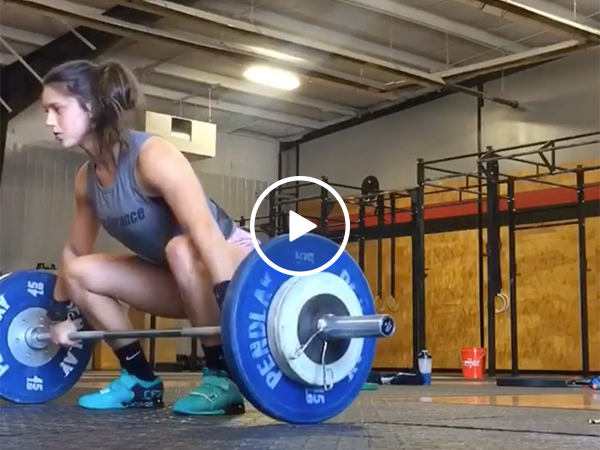 Ripped girl drops bar on her neck