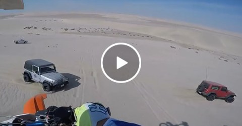 Guy accidentally hits jeep after jumping 100ft off sand dune (Video)