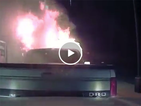 Hero police officer pushes burning truck away from building (Video)