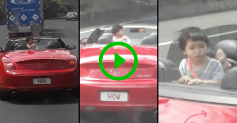 Kid walks around back of moving convertible (Video)