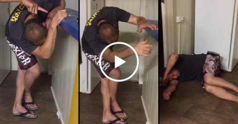 Drunk man holding onto counter takes hard tumble to the floor (Video)