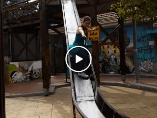 Woman in glasses attempts slide standing up, in hilarious fail (Video)