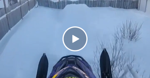 Man jumps his snowmobile through his neighborhood (Video)
