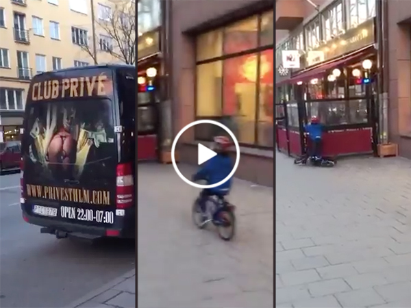 Kid crashes bike while looking at strip club advertisement