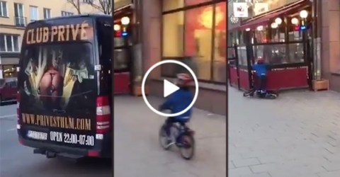 Kid crashes bike while looking at strip club advertisement