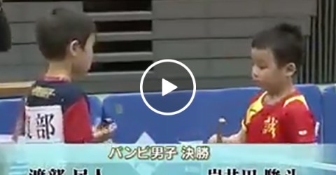 Young kids play intense ping pong game