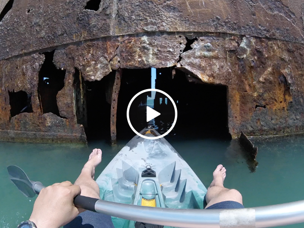 Man takes his kayak on an adventure inside an abandoned ship