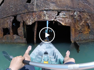 Man takes his kayak on an adventure inside an abandoned ship