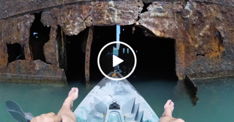 Man takes his kayak on an adventure inside an abandoned ship