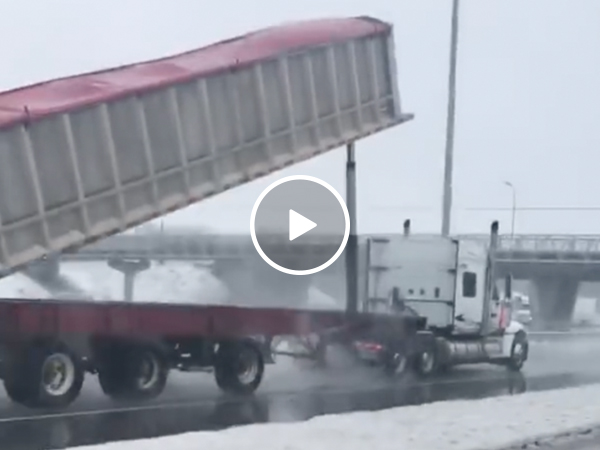 Raised truck bed hits bridge in an explosion of seeds (Video)