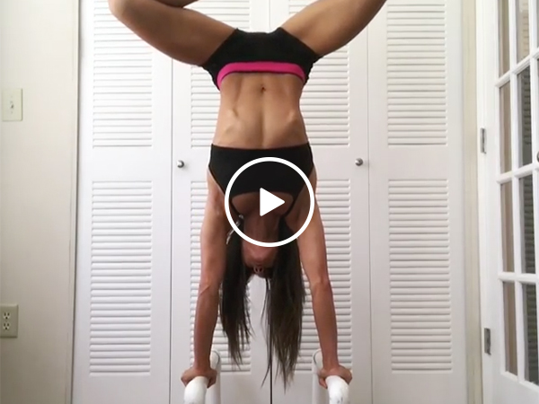 Hot girl in a Sports Bra Performs An Upside Down Handstand