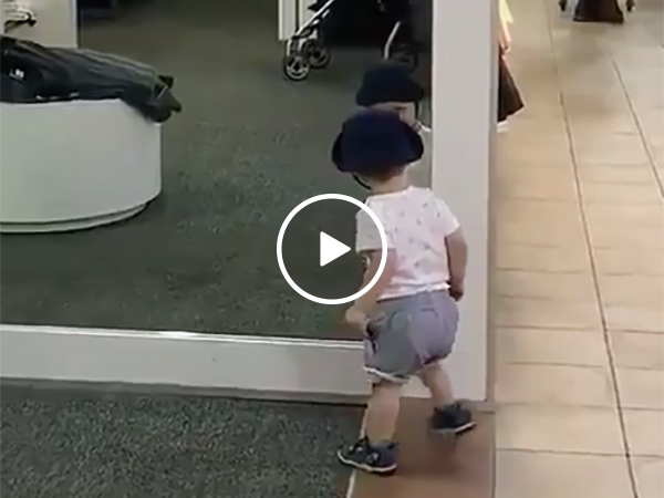 Kid At a Shopping Mall Is Confused By a Mirror