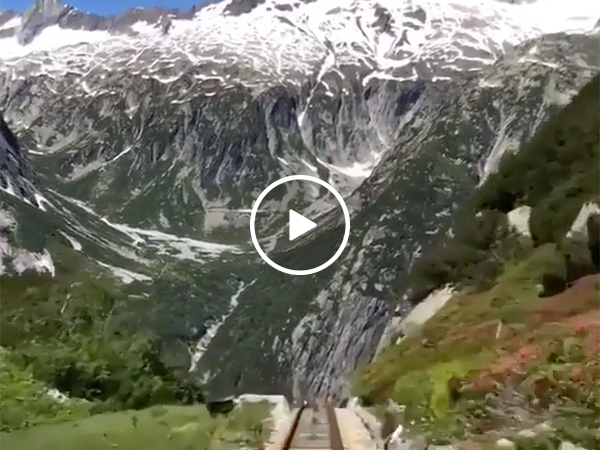A roller coaster Perched in the Swiss Alps with a Mountainous View