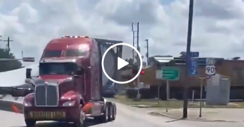 Train smashes through a semi-truck hauling a wind turbine blade (Video)